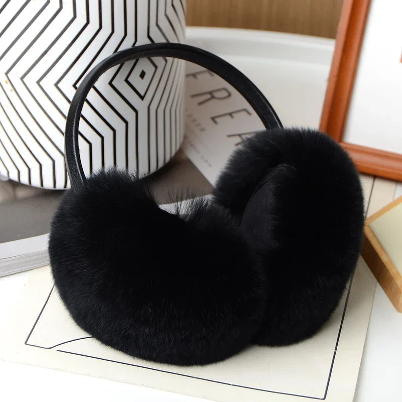 a pair of black ear muffs sitting on top of a table