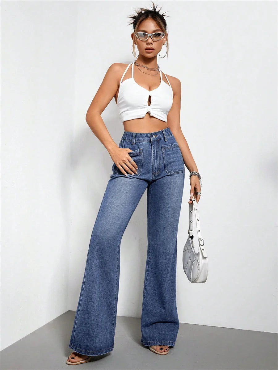 a woman in a white crop top and jeans