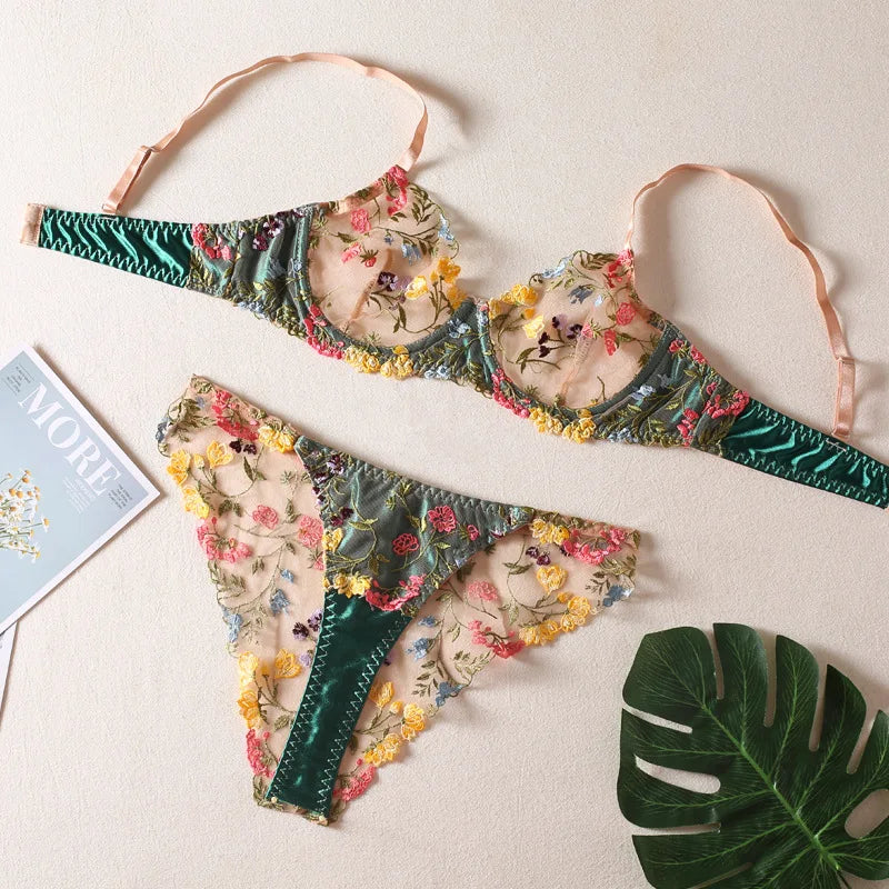 a pair of bikinis sitting on top of a table next to a plant