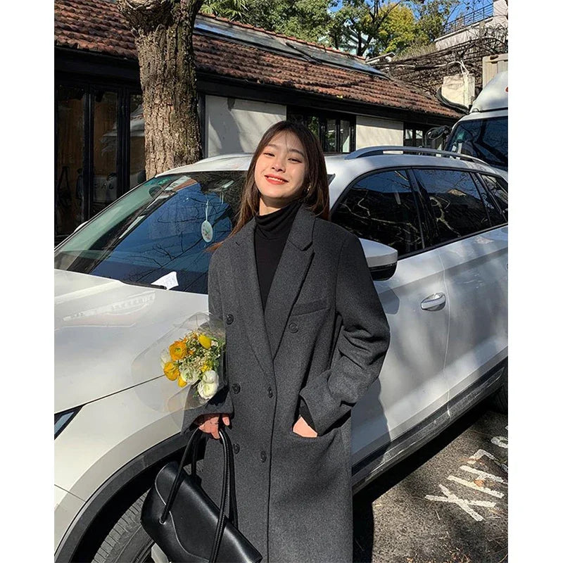 a woman standing next to a car holding a bouquet of flowers