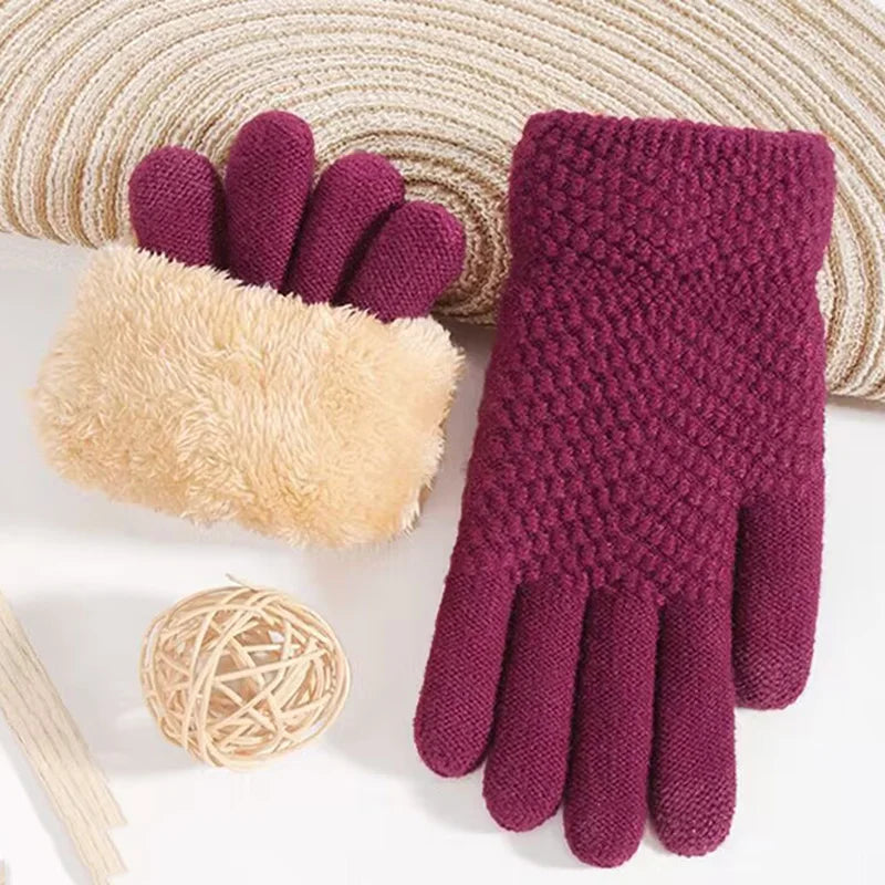 a pair of gloves and a ball of yarn