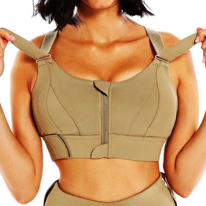 a woman in a tan sports bra with zippers