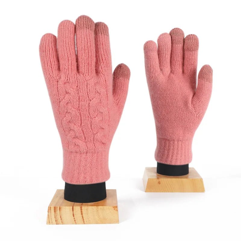 a pair of pink gloves sitting on top of a wooden stand