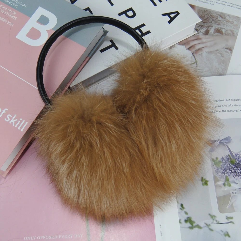 a pair of scissors and a fur ball on top of a magazine