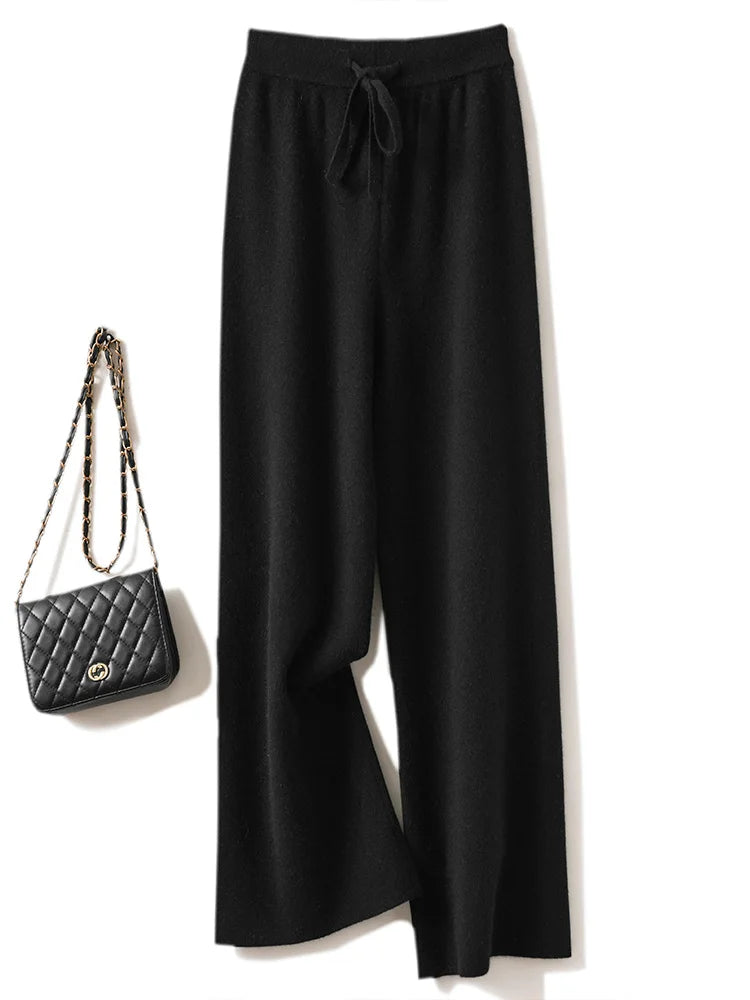 a woman's black pants with a handbag next to it