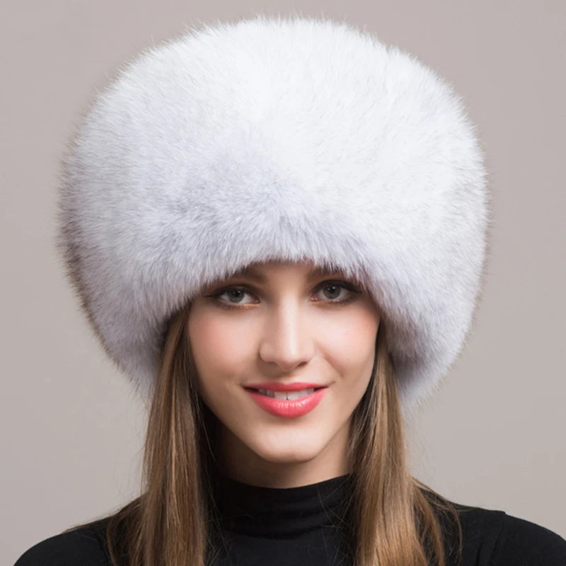 Soft white natural fox fur hat on a model, emphasizing its luxurious and warm characteristics.