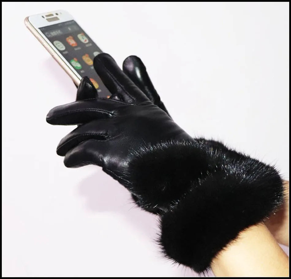 a person wearing black gloves holding a cell phone