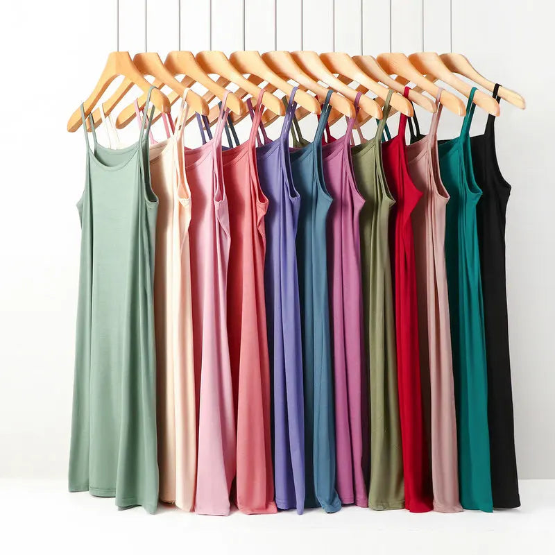 a bunch of dresses hanging on a rack