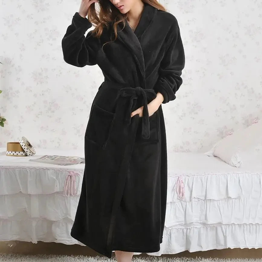 a woman in a bathrobe standing on a bed