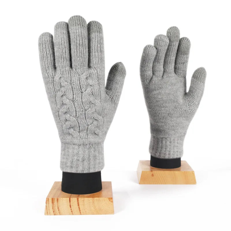 a pair of gloves sitting on top of a wooden stand