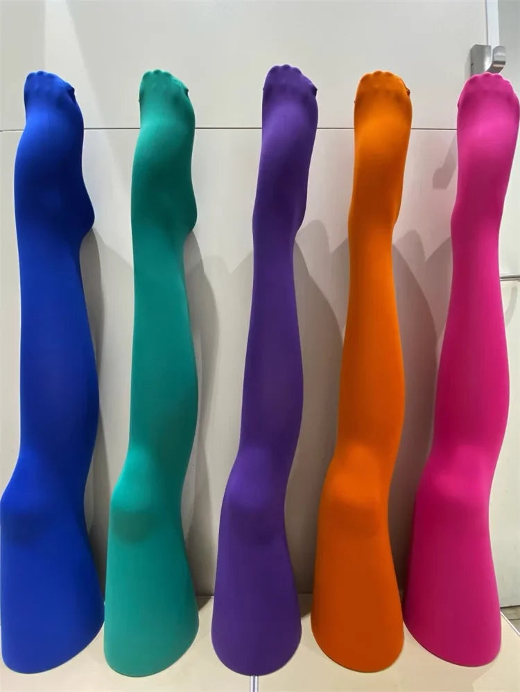 a row of different colored vases on a wall