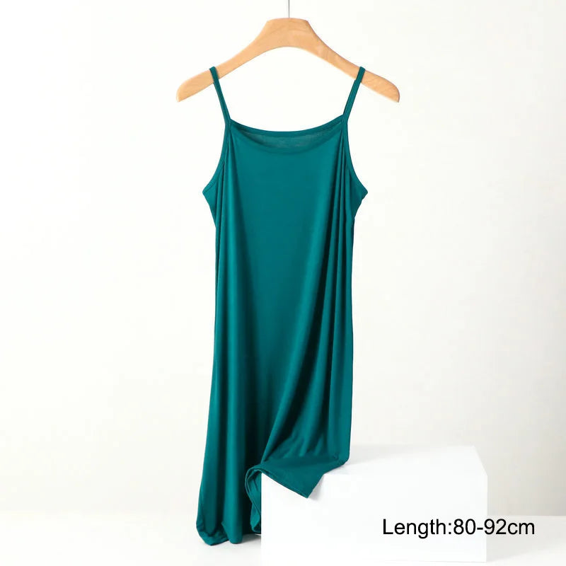 a green dress hanging on a wooden hanger