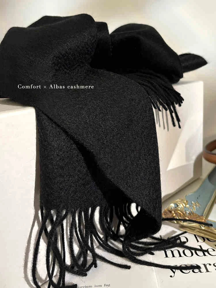 a black scarf sitting on top of a table