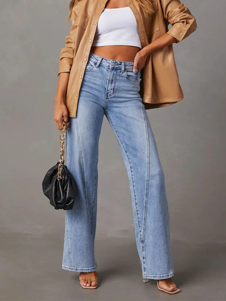 a woman wearing a tan jacket and jeans