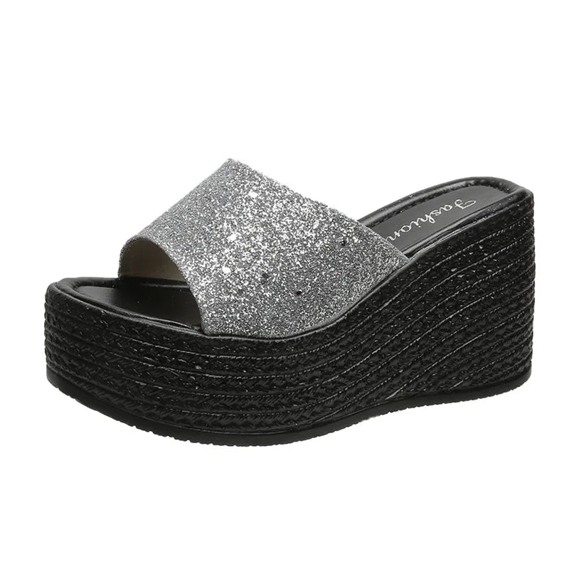 a women's silver platform sandal with a wedged bottom