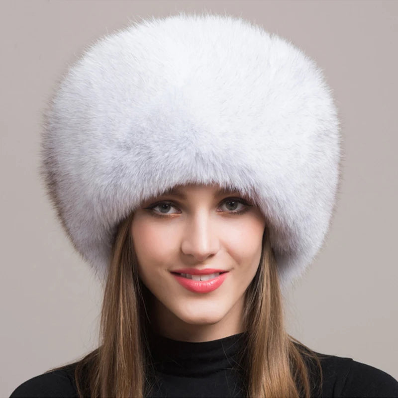 Model wearing a soft white natural fox fur hat, exuding charm and warmth.