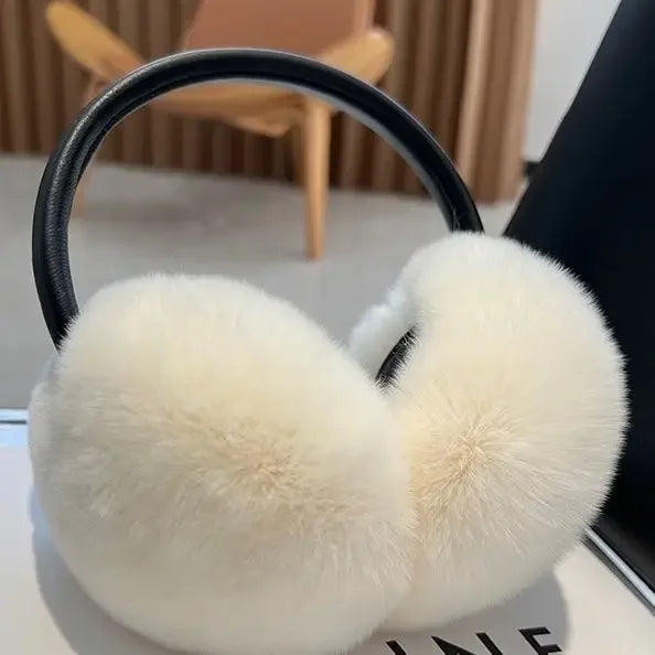 a pair of white ear muffs sitting on top of a table