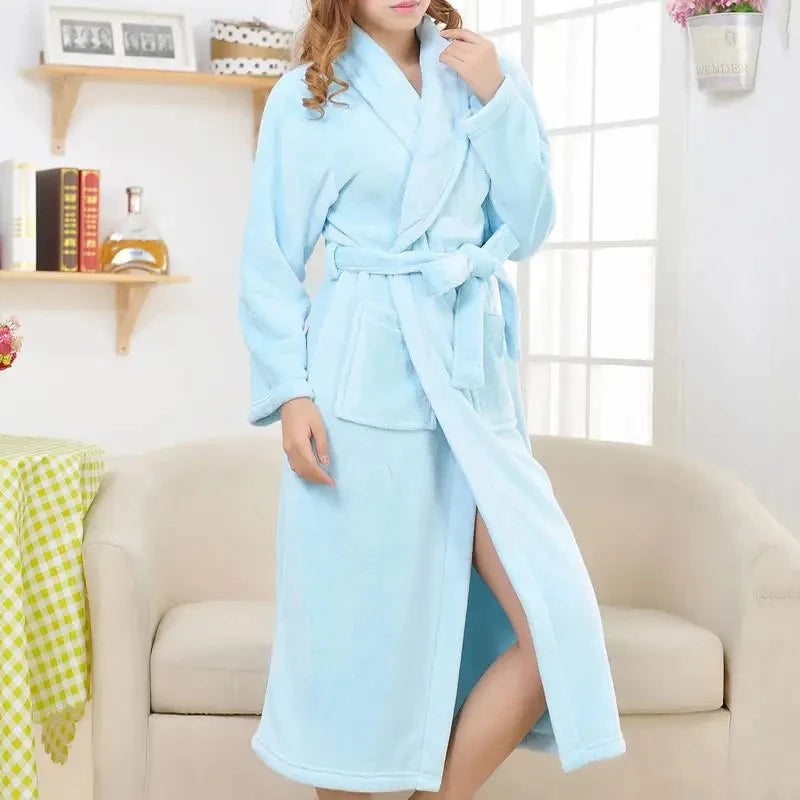 a woman in a blue robe standing in a living room