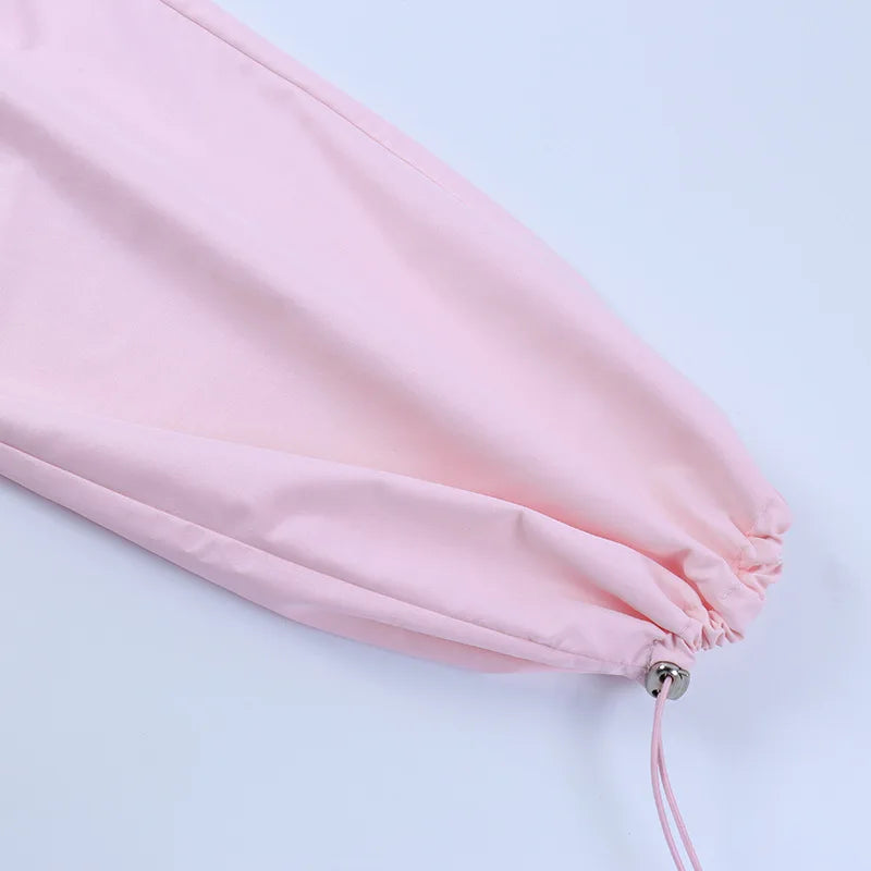 a pink umbrella laying on top of a white table