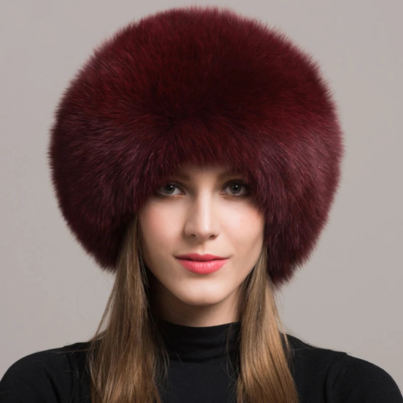 Burgundy natural fox fur hat elegantly worn by a model, perfect for winter fashion.