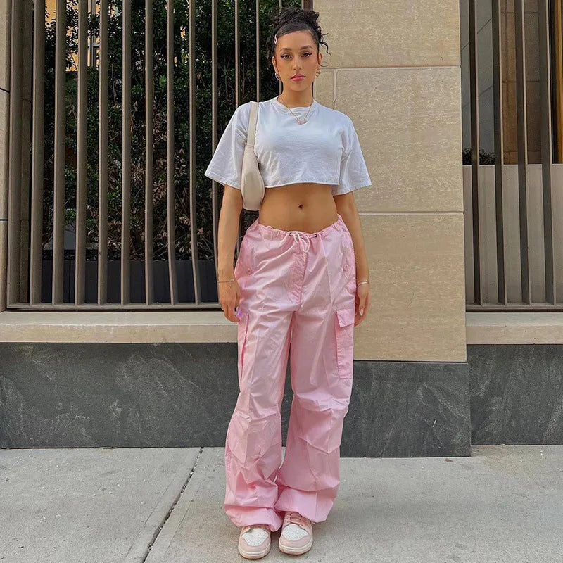 a woman wearing pink pants and a crop top