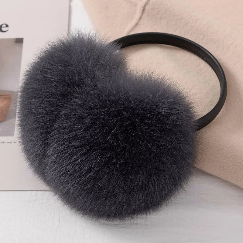 a black fluffy ball on a black headband