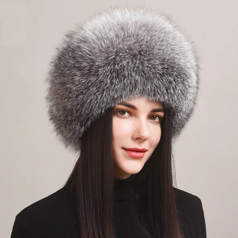 Trendy grey natural fox fur hat worn by a model, showcasing a modern and sleek style.