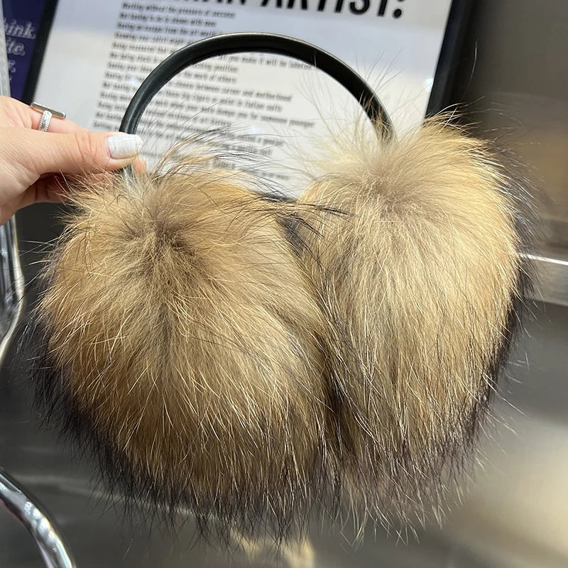 a person is holding a furry ear muffs