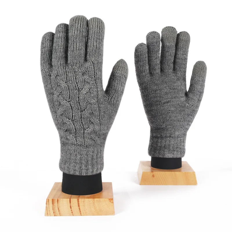 a pair of gloves sitting on top of a wooden stand