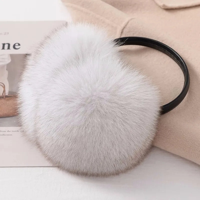 a white fur ball on top of a magazine