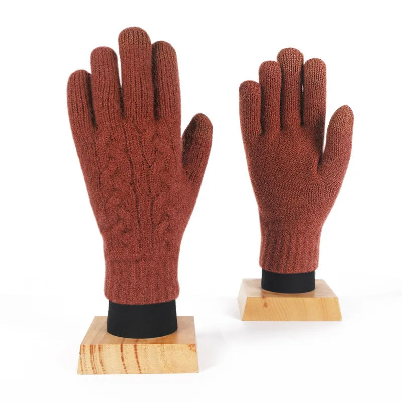 a pair of red gloves sitting on top of a wooden stand