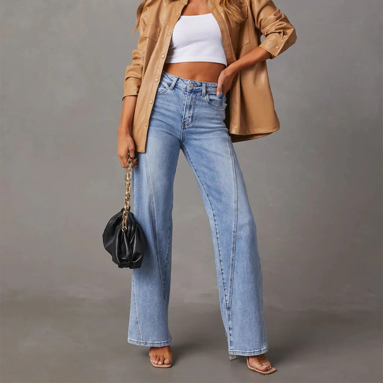 a woman wearing a tan jacket and jeans