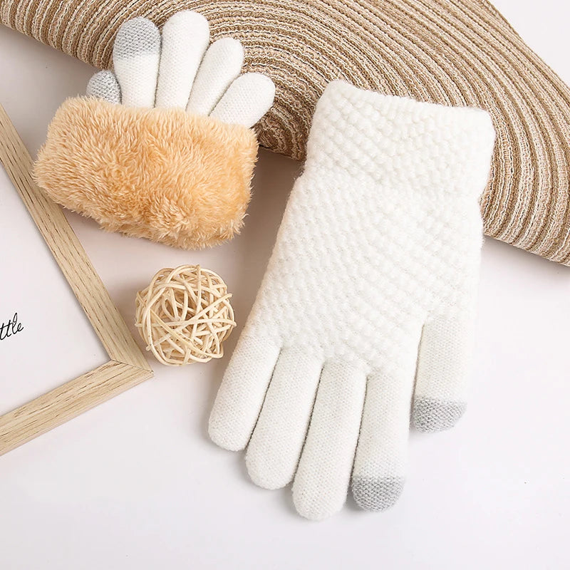 a pair of white gloves sitting on top of a pillow