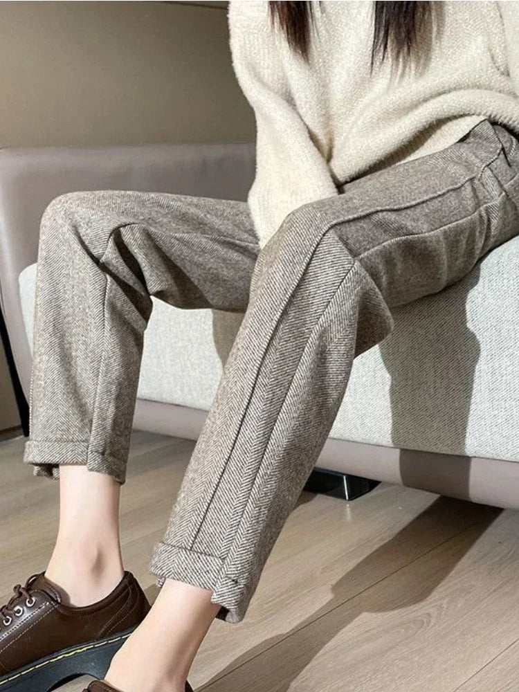 a woman sitting on a couch wearing brown shoes