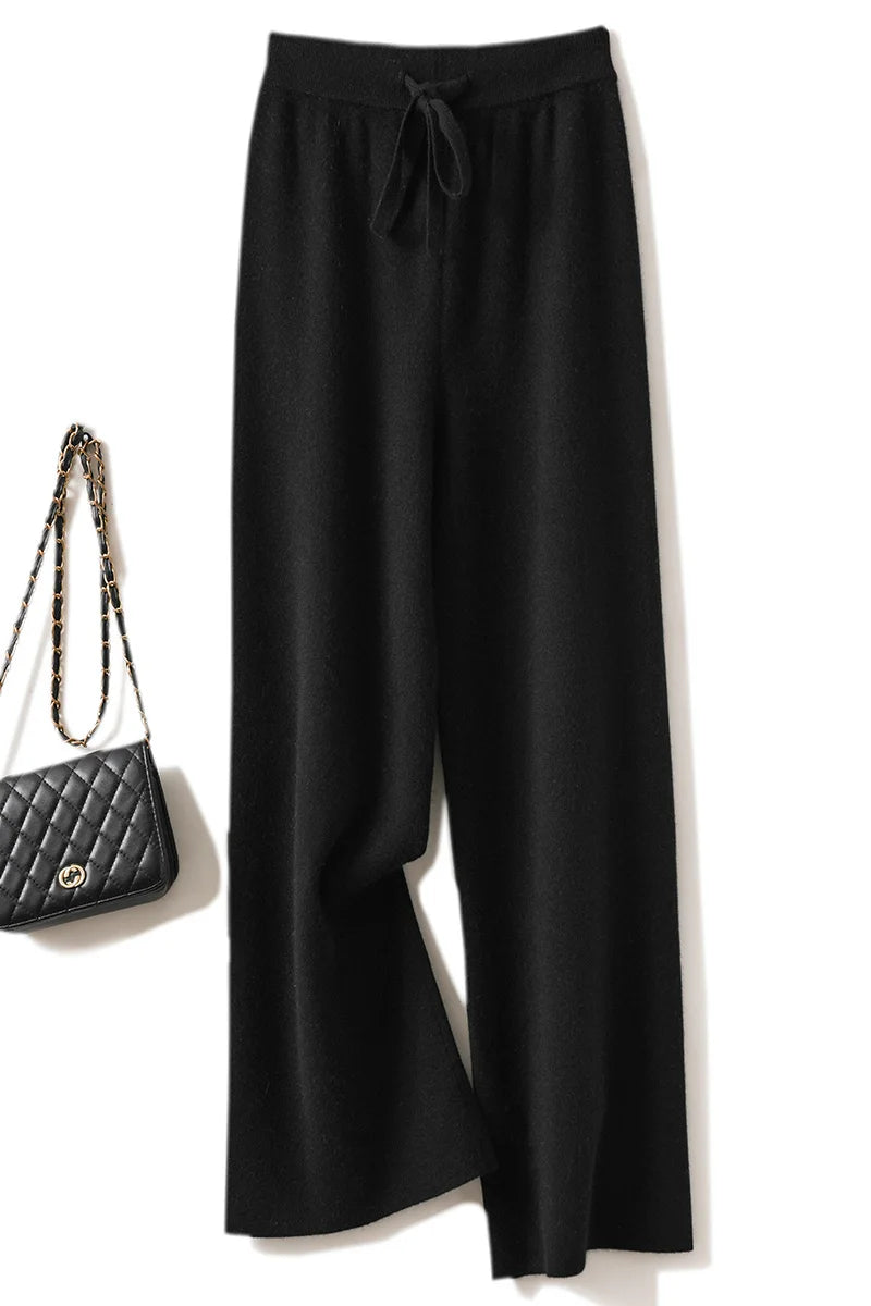 a woman's black pants with a handbag next to it