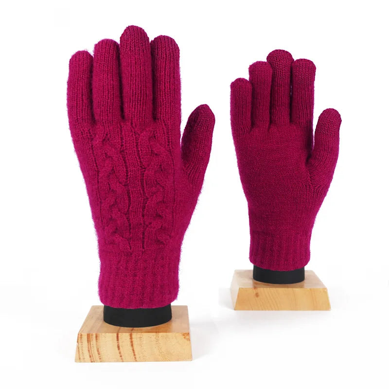 a pair of pink gloves sitting on top of a wooden stand