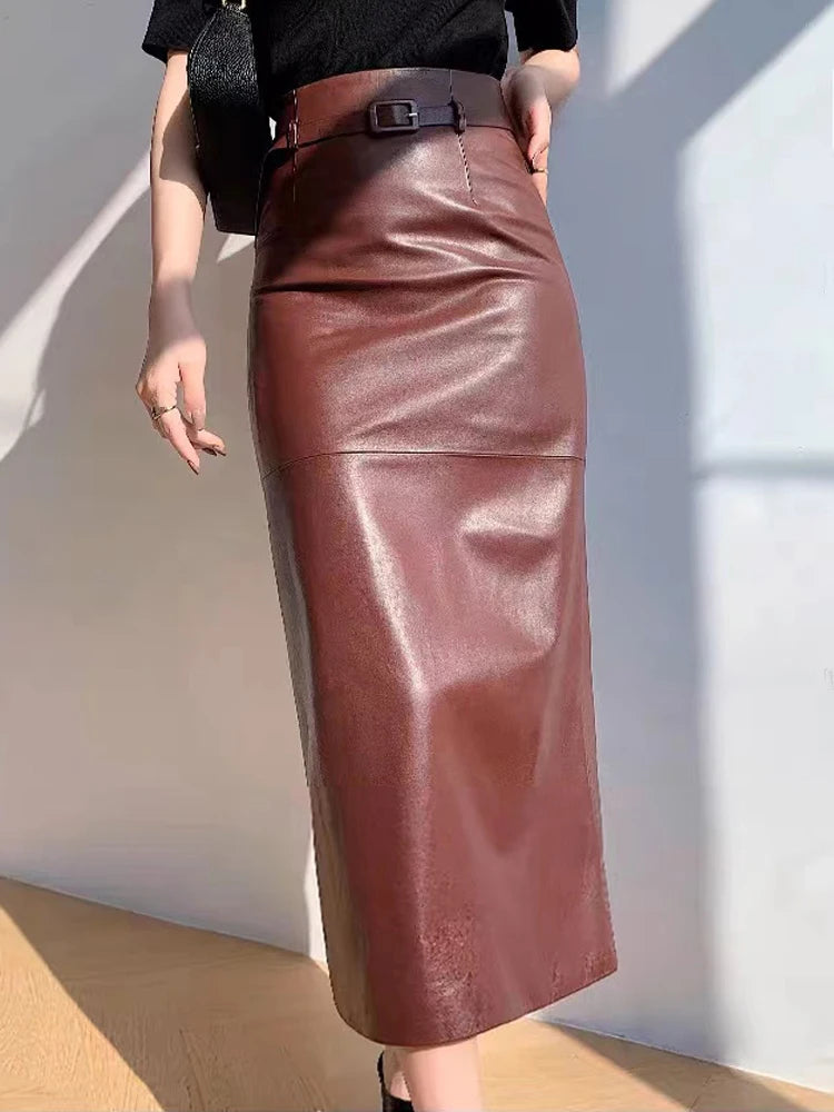 a woman in a black shirt and a brown leather skirt