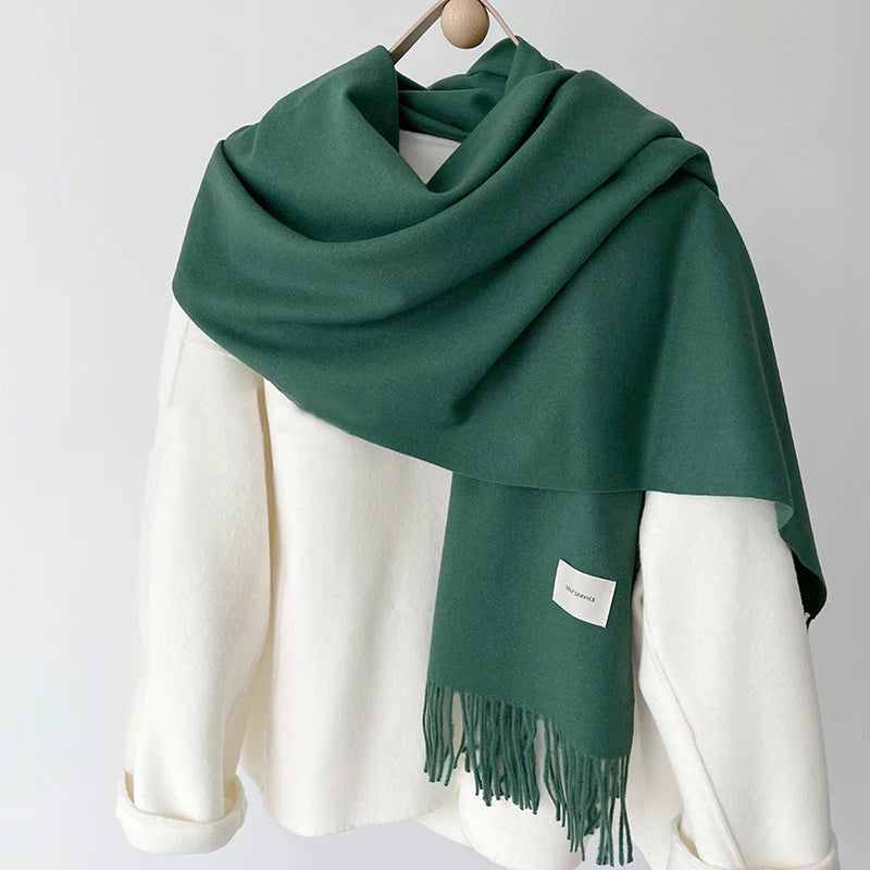 a green and white scarf hanging on a coat rack