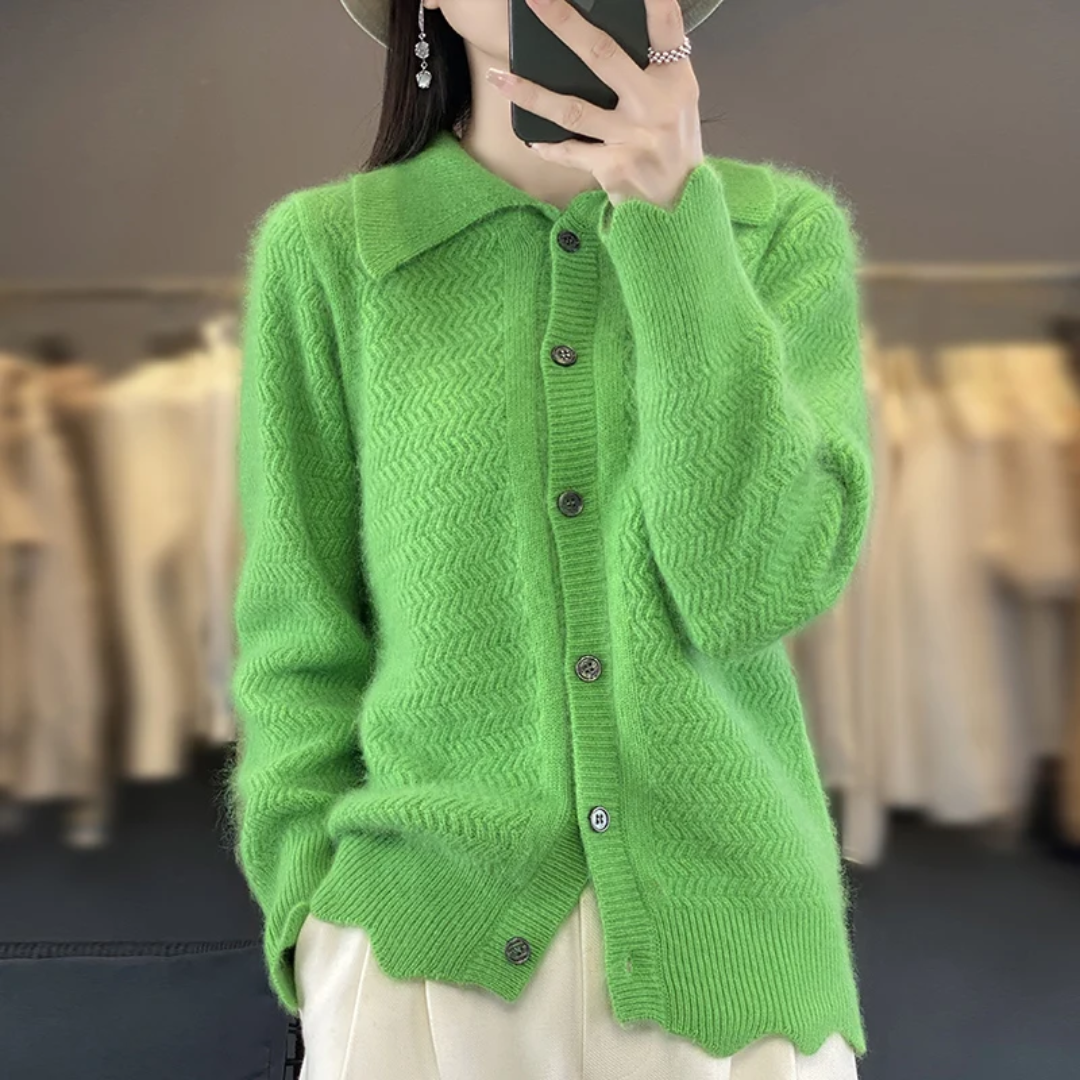 a woman in a green cardigan taking a selfie