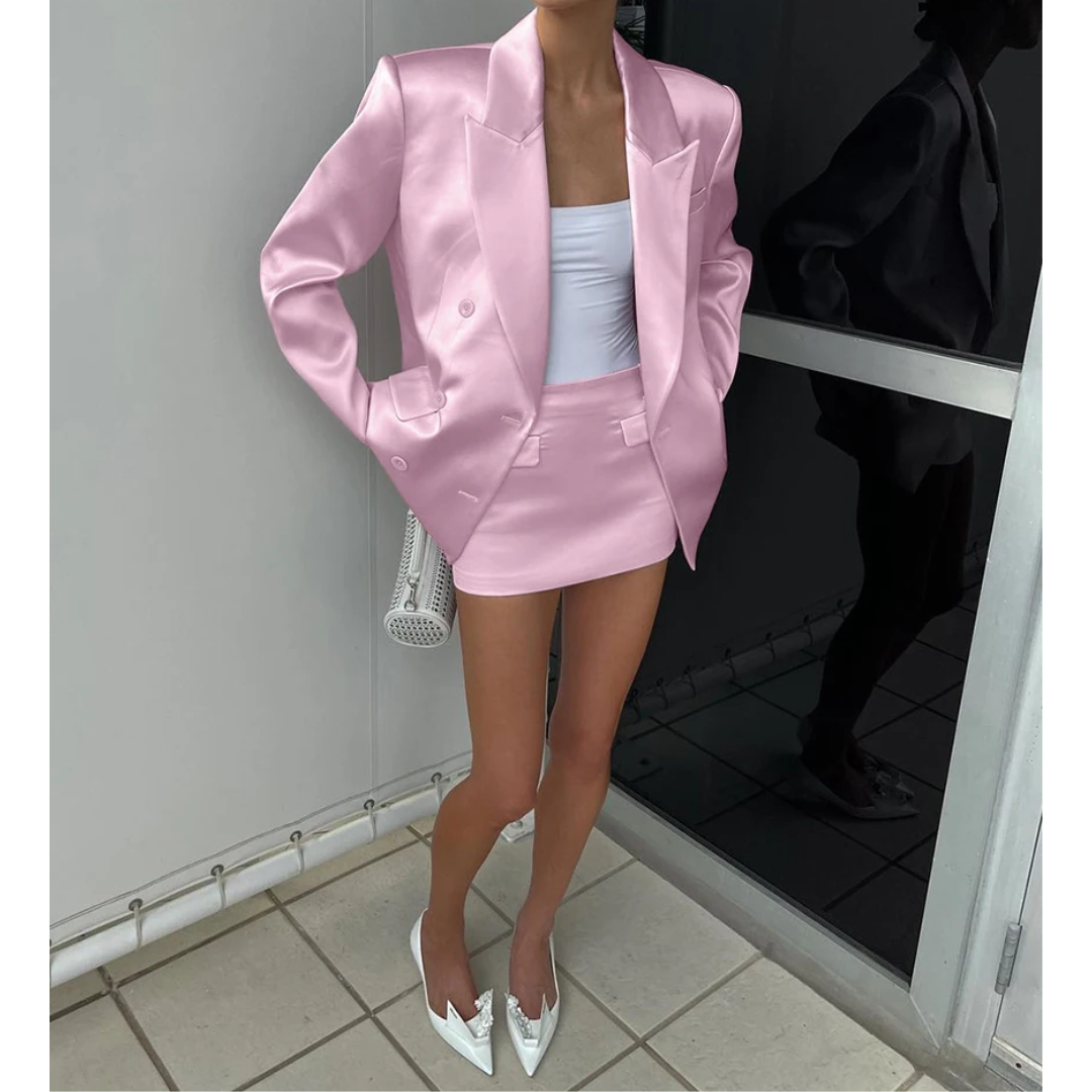 a woman wearing a pink suit and white shoes
