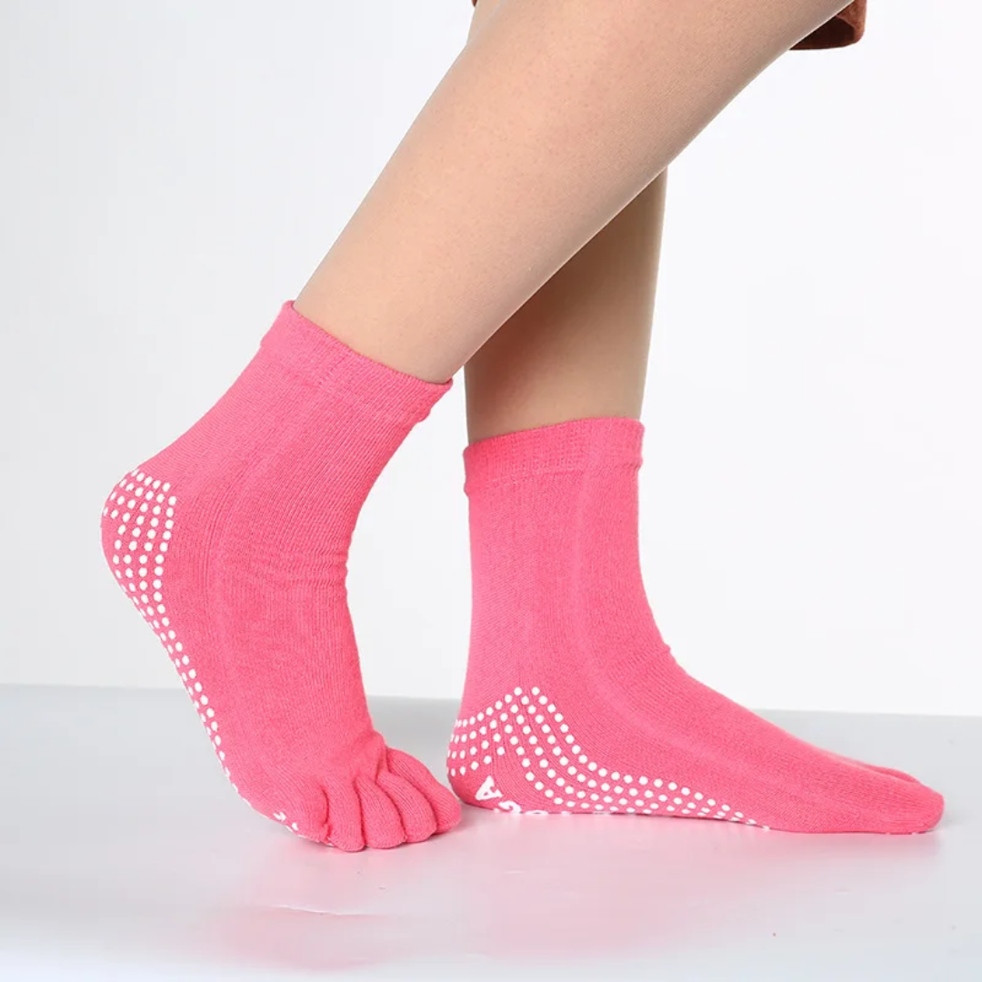 a woman's legs with pink socks and polka dots