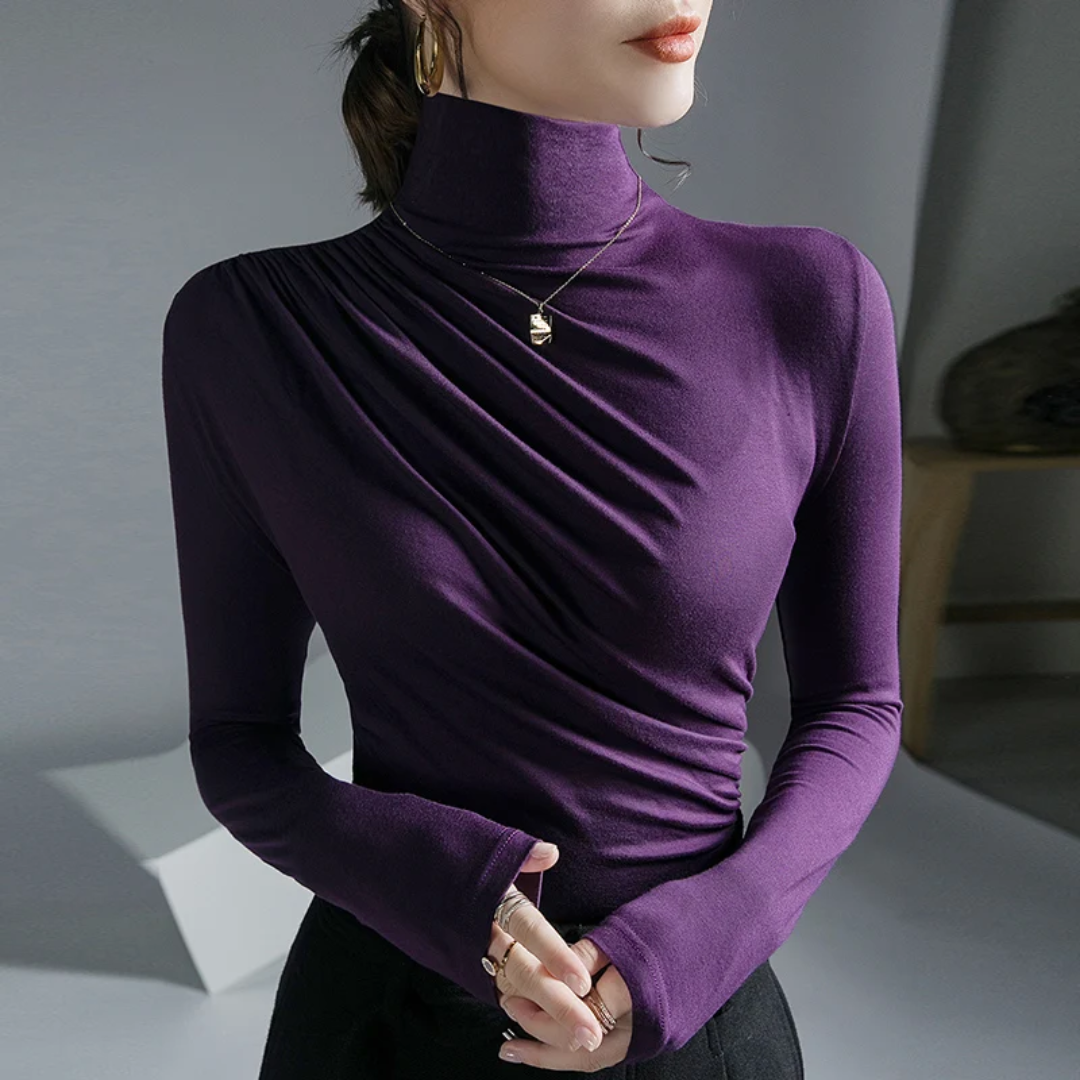 a woman wearing a purple shirt and black pants