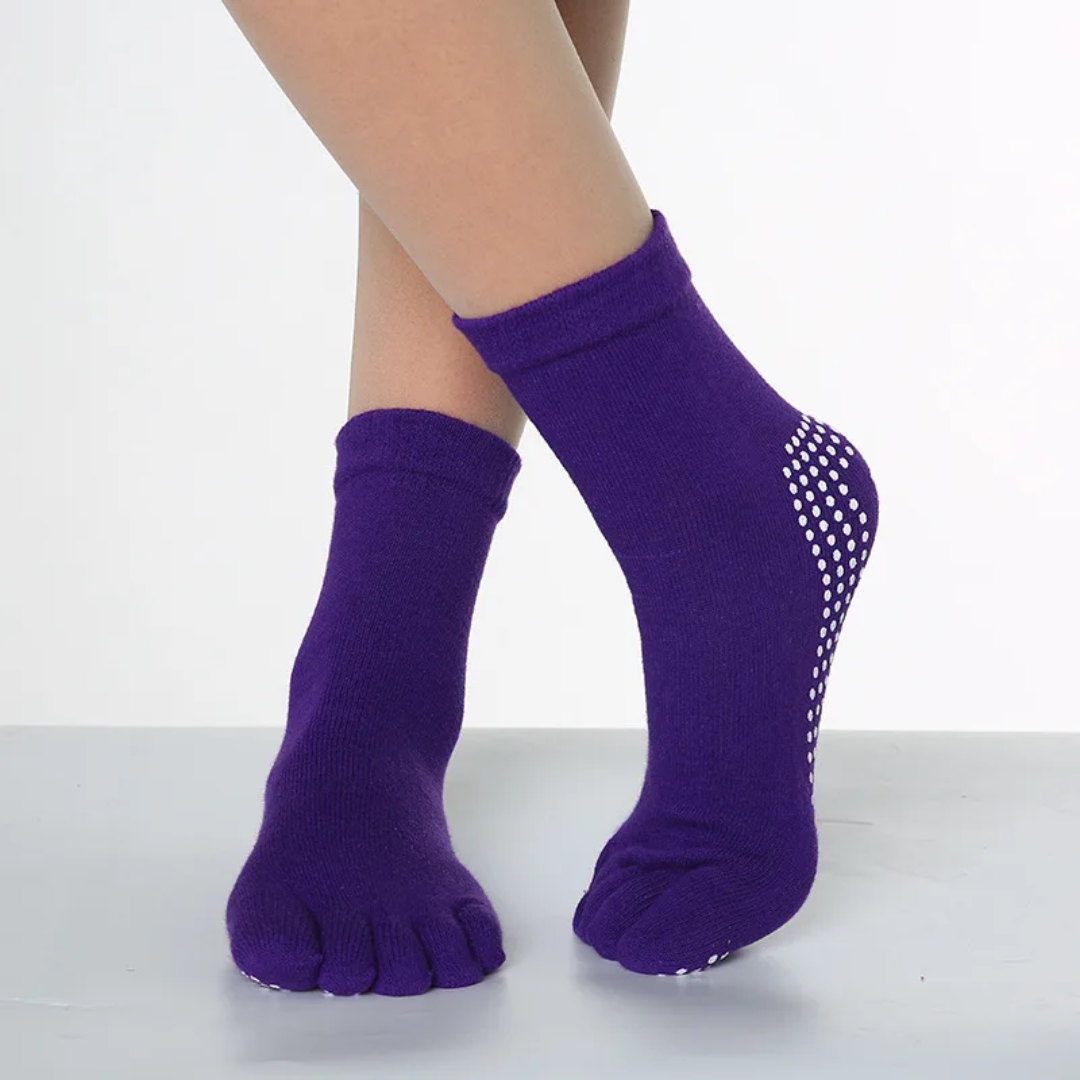 a woman's legs with purple socks and polka dots