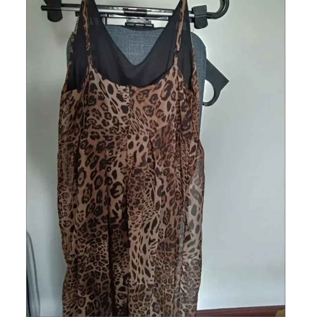 a leopard print dress hanging on a hanger
