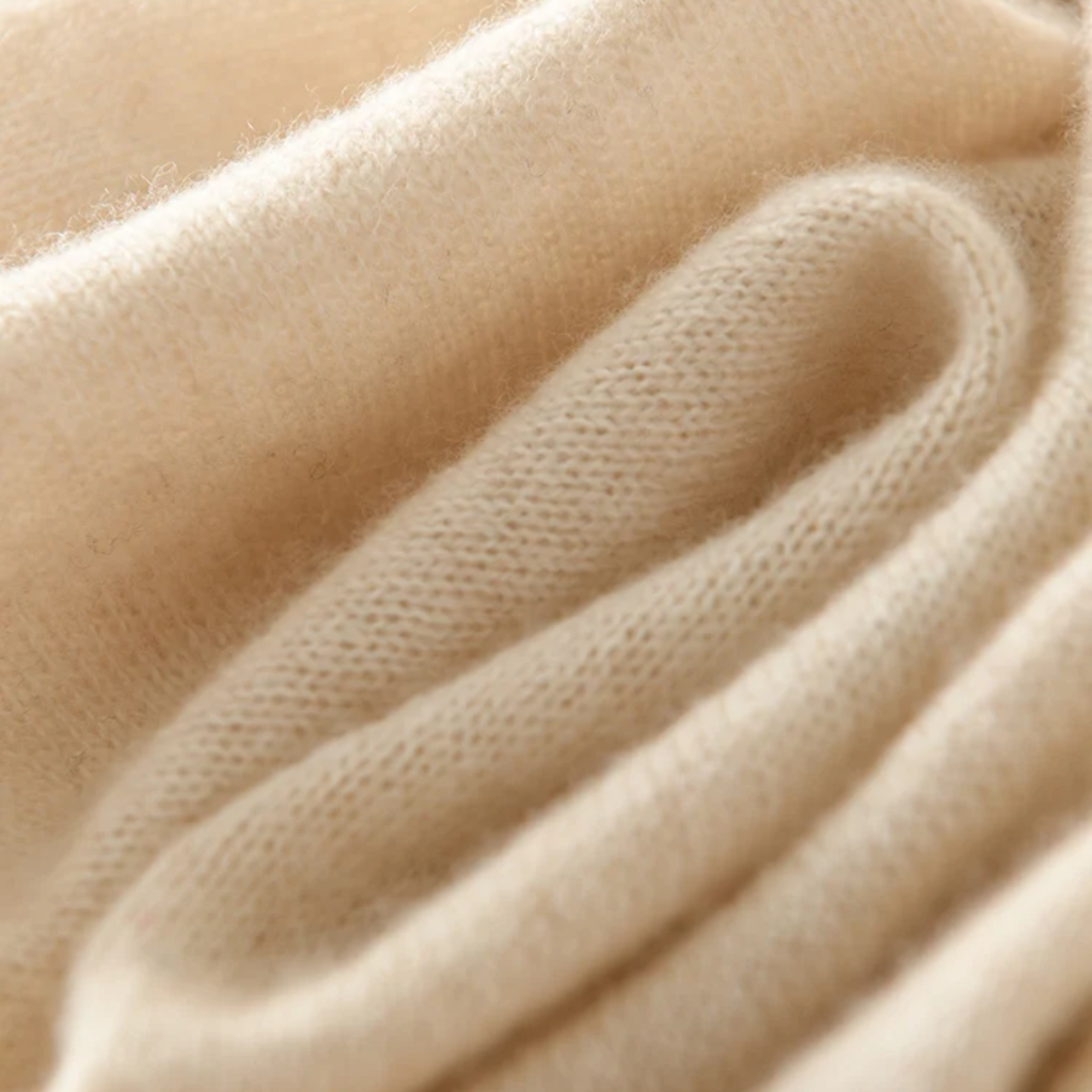 a close up view of a beige sweater