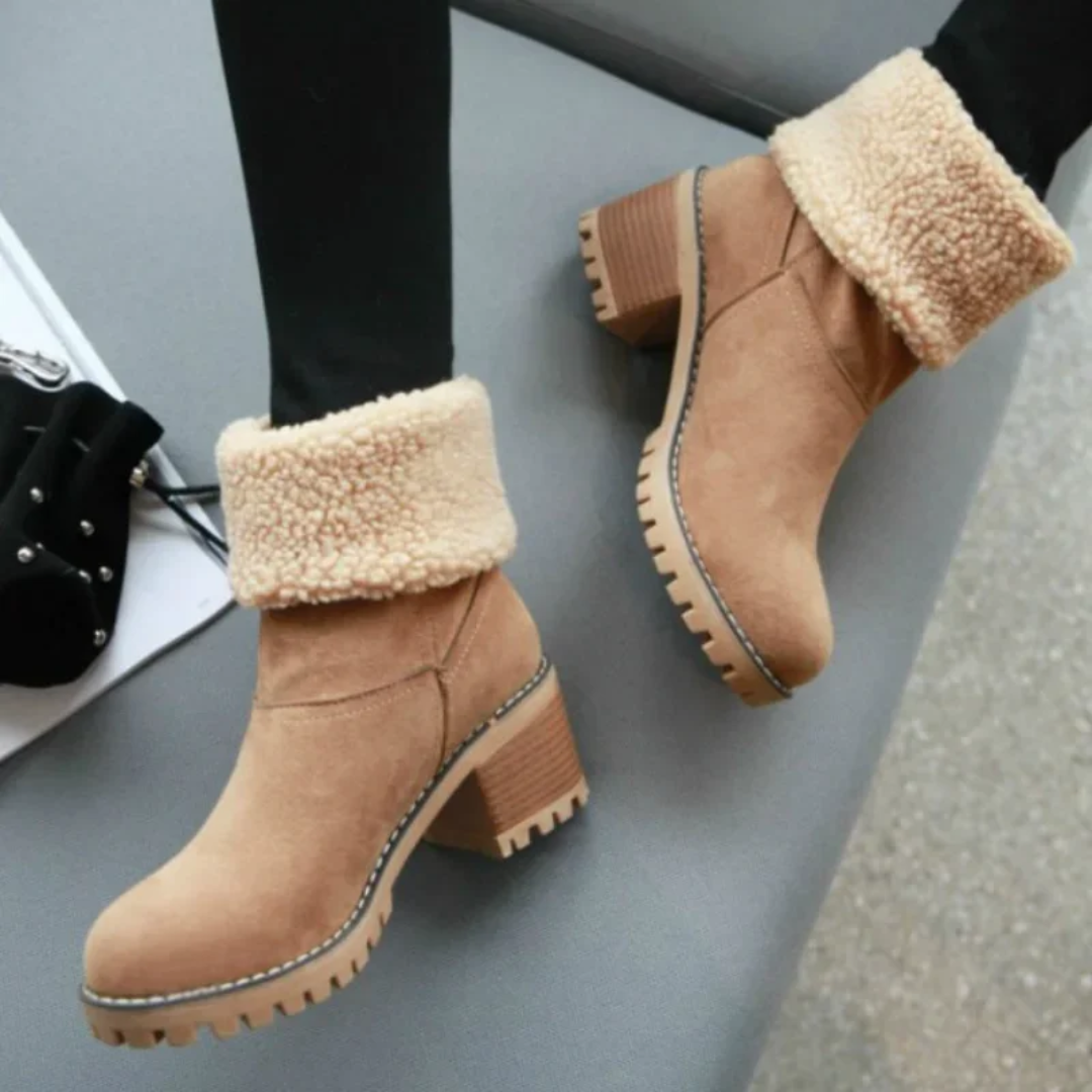 a pair of women's boots on a table