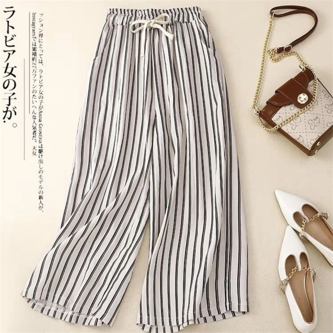a pair of striped pants next to a purse
