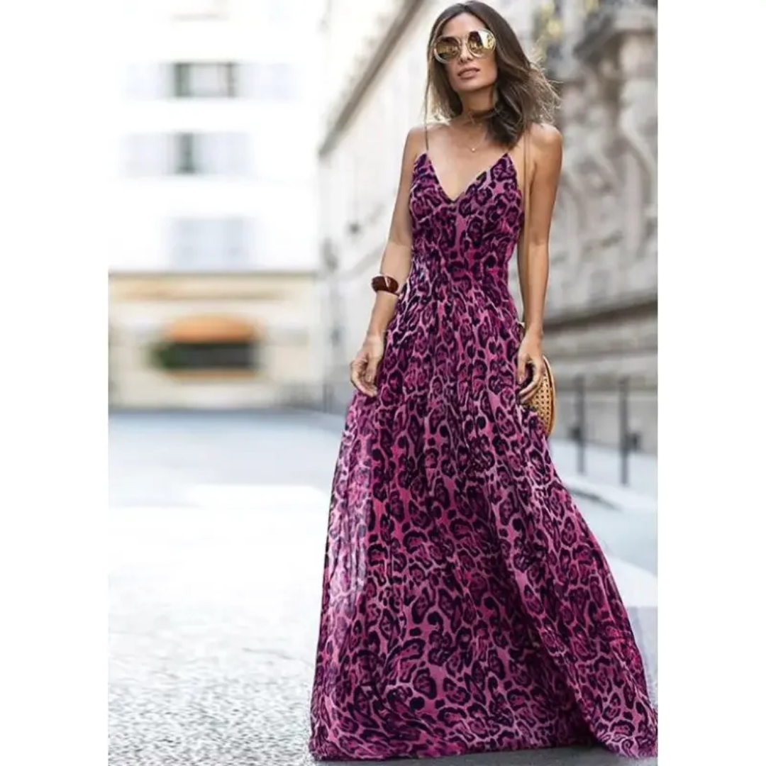 a woman in a purple dress is walking down the street