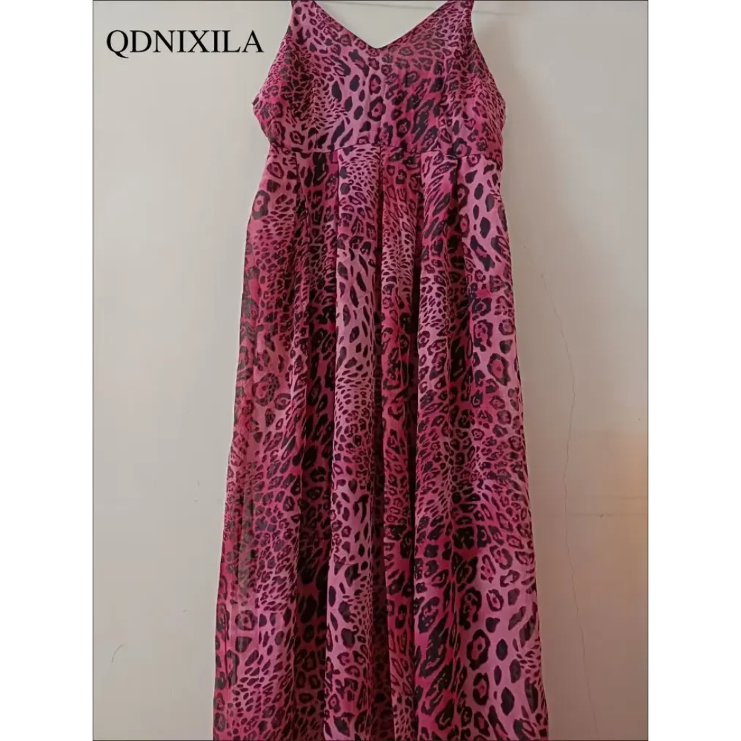 a pink and black animal print dress hanging on a wall