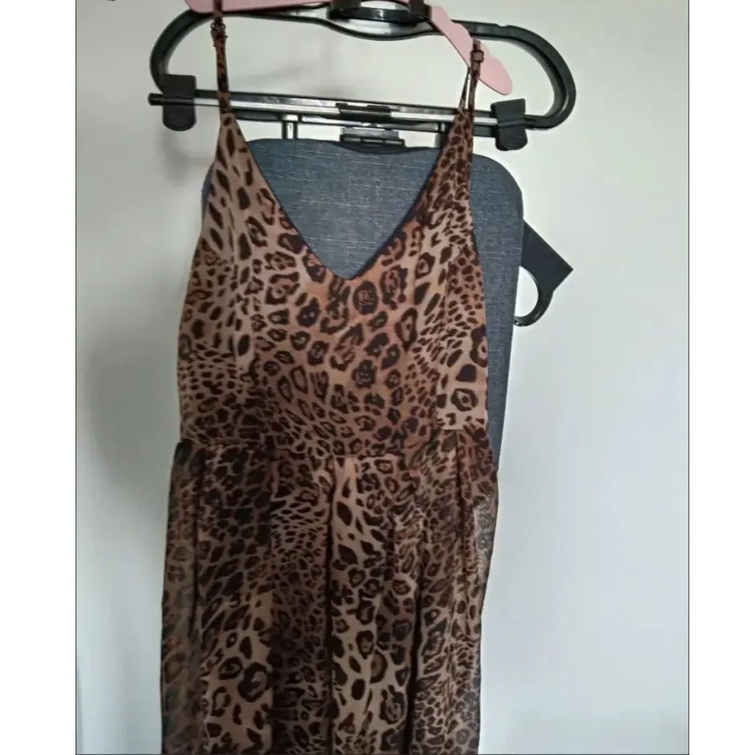 a leopard print dress hanging on a hanger